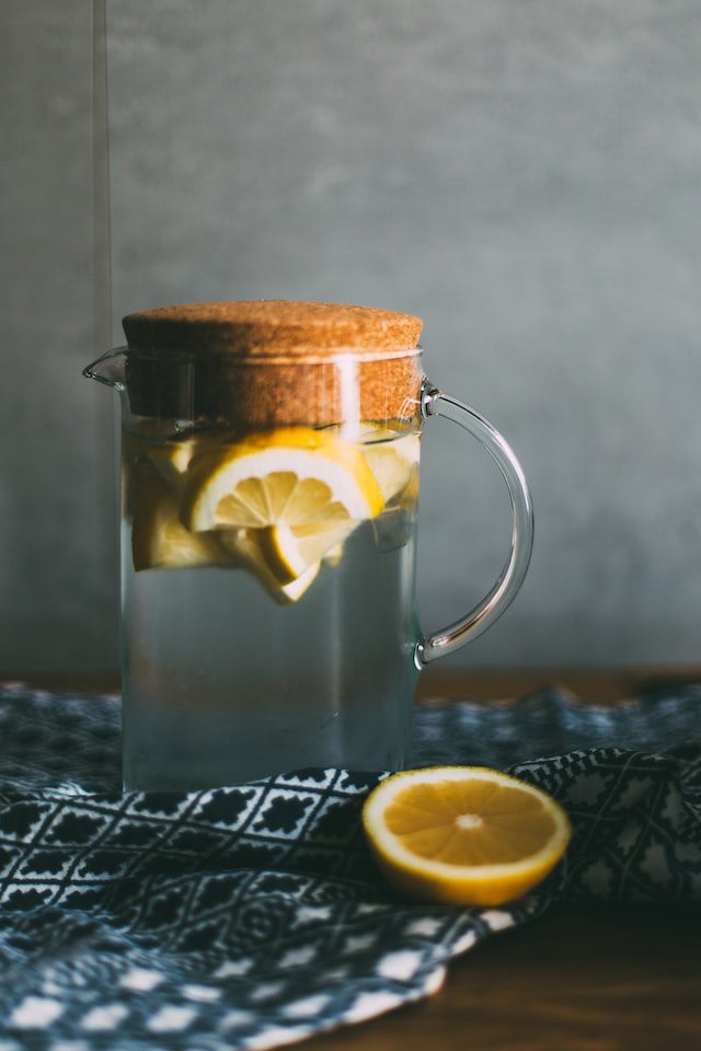 pitcher of water with lemon in it