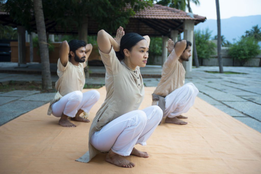 group of performing Yoga Namaskar Pose with hands in prayer position, demonstrating balance, focus, and traditional yoga posture."