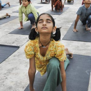 Group of kids doing Surya Shakti ( a yogic practice)